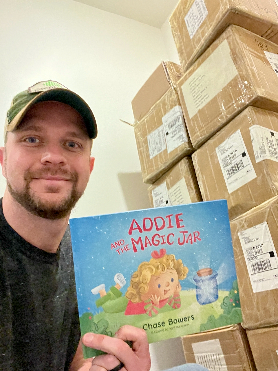 Chase holding the book with shipping boxes